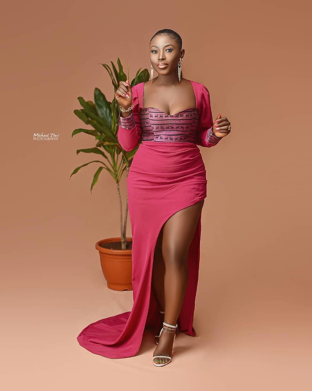 Client in a fuchsia slit gown with a beaded bodice