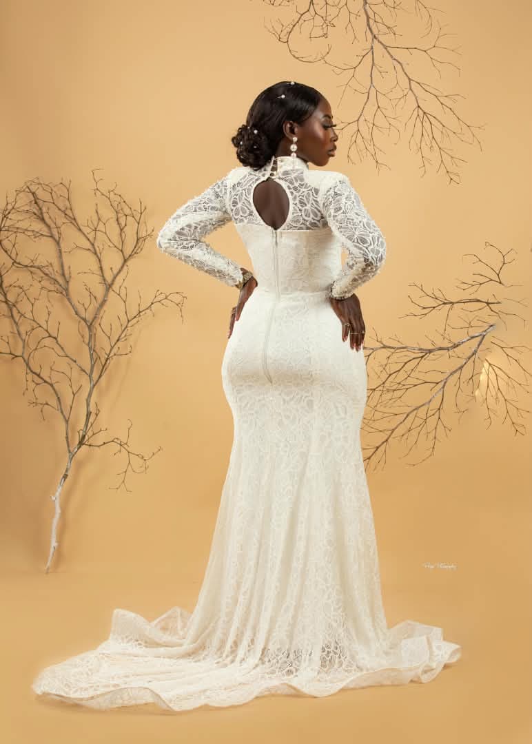 Client in an ivory lace mermaid gown with a keyhole back